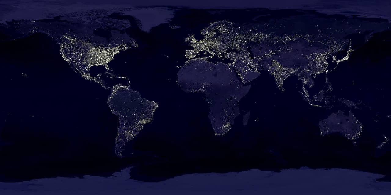 view of the earth from space showing illuminated sections by electricity